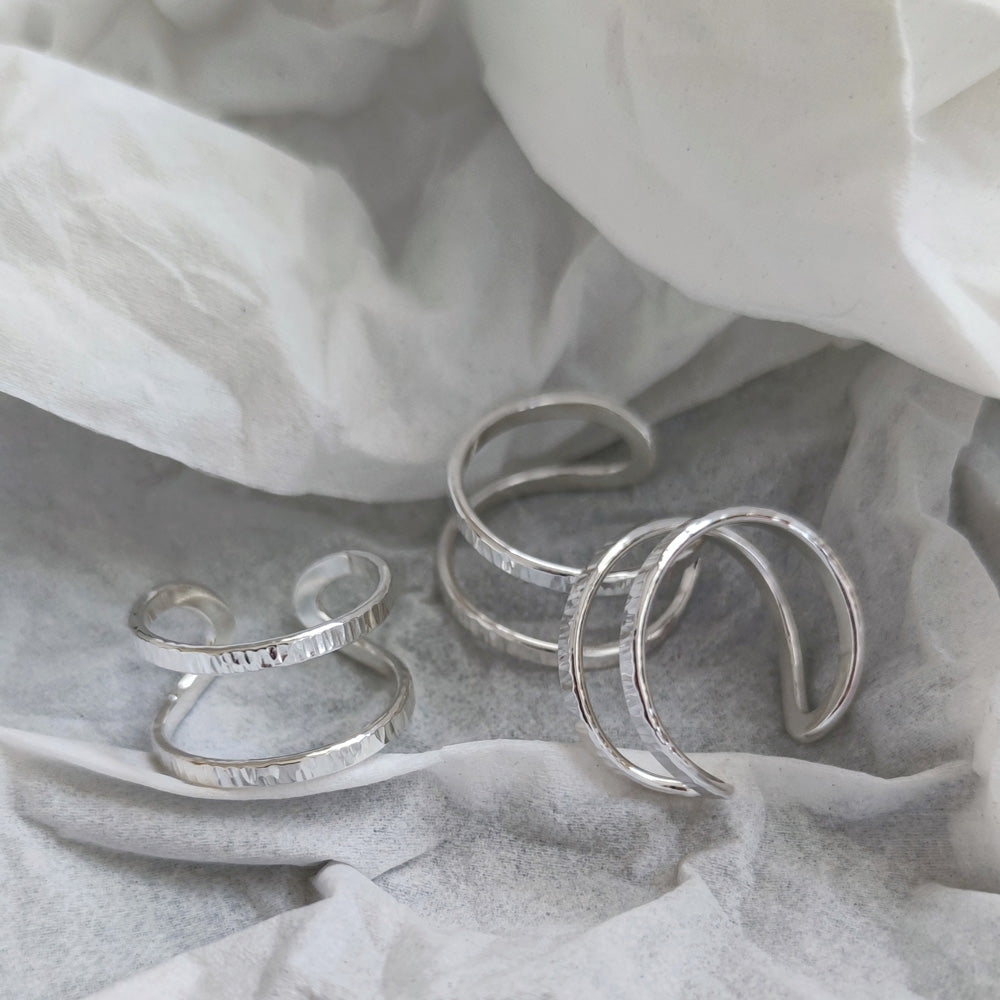 handmade sterling silver wrap rings by aurelium on crumpled paper